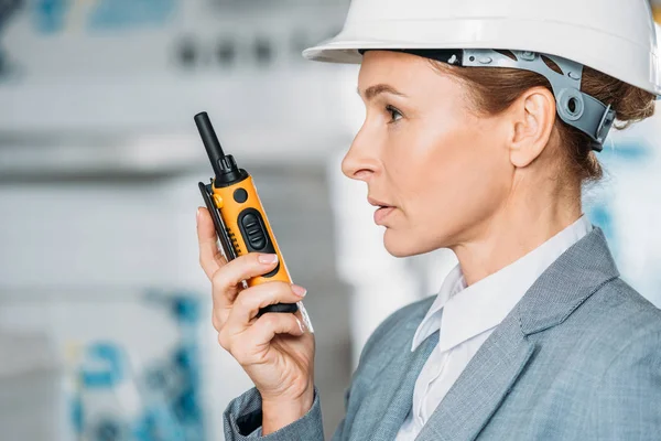 Female inspector in helmet with walkie talkie in shipping stock — Stock Photo