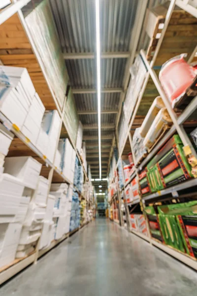 Blurred view of shelves with boxes in storehouse — Stock Photo