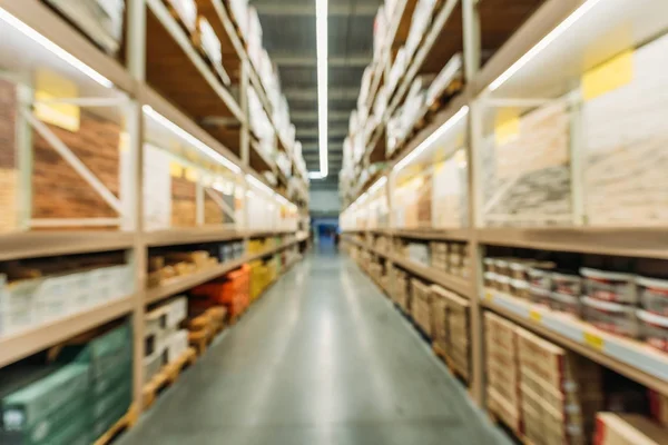 Blurred view of shelves with boxes in storage — Stock Photo