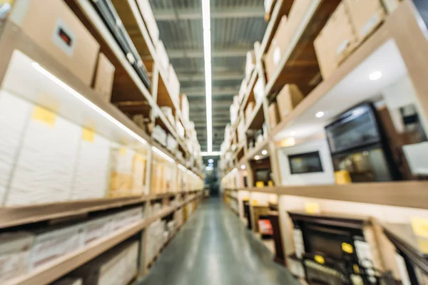 Blurred view of shelves with boxes in warehouse — Stock Photo