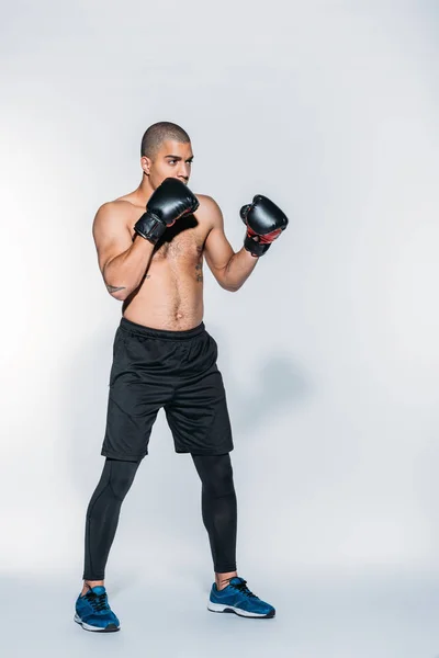 Entrenamiento de boxeador afroamericano muscular en blanco - foto de stock