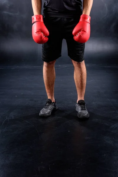 Cropped shot of boxer in gloves on black — Stock Photo