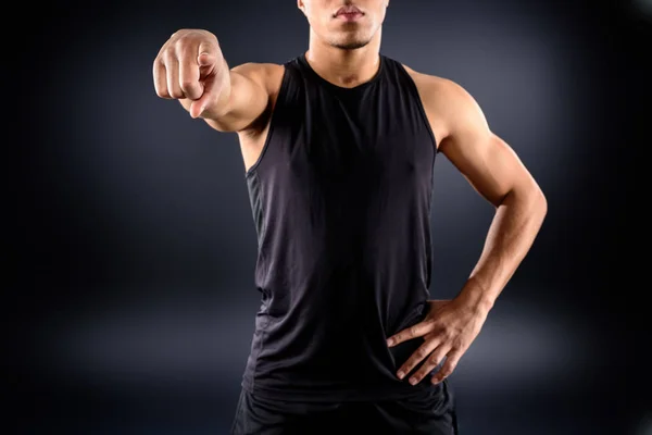 Cropped shot of african american sportsman pointing at camera on black — Stock Photo