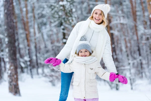 Portrait of happy young family in winter park — Stock Photo