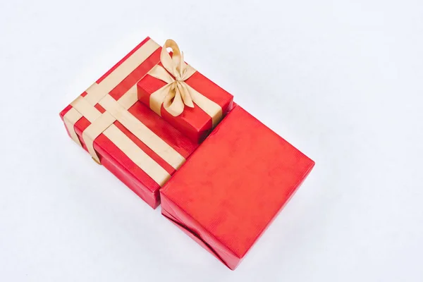 Top view of red gift boxes with golden ribbons isolated on grey — Stock Photo