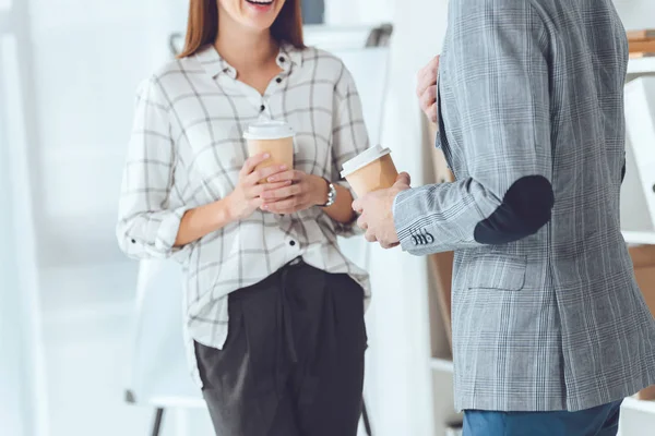 Cropped image of male and female colleagues having coffee break in office — Stock Photo