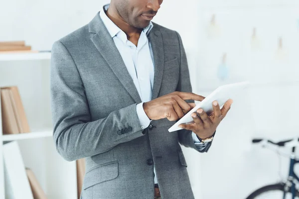 Cropped image of african american man using tablet — Stock Photo