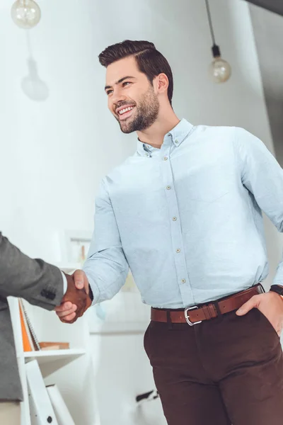 Cropped image of african american and caucasian businessmen shaking hands — Stock Photo