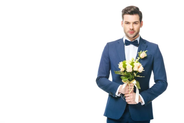 Portrait of stylish groom in suit with wedding bouquet isolated on white — Stock Photo