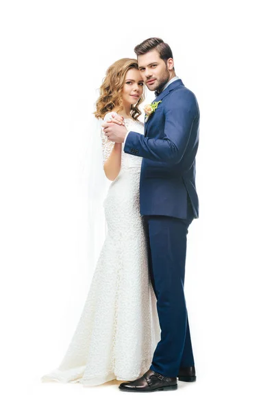 Young bride and groom dancing together isolated on white — Stock Photo