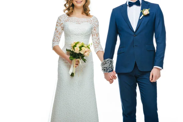 Cropped shot of chained wedding couple holding hands isolated on white — Stock Photo