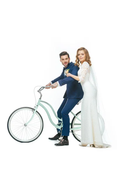 Wedding couple riding retro bicycle isolated on white — Stock Photo
