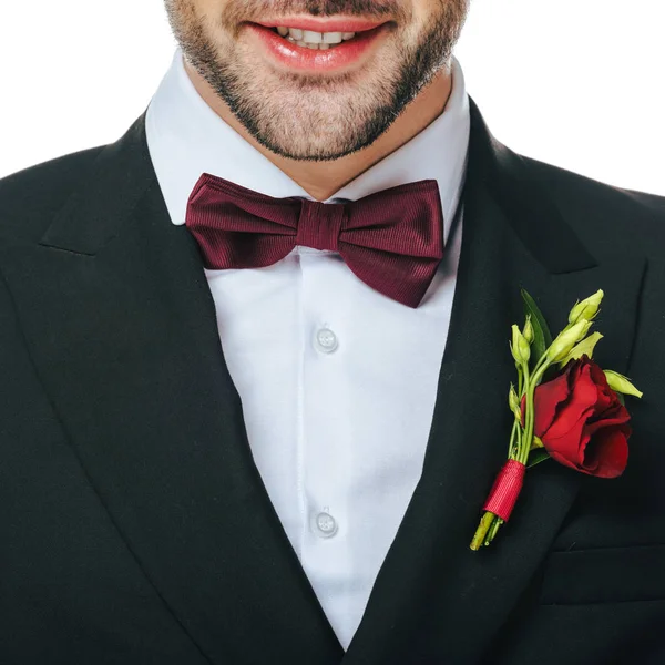 Vista parcial del novio en traje con boutonniere aislado en blanco - foto de stock