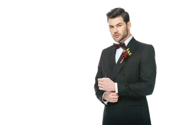 Handsome young groom in suit with boutonniere isolated on white — Stock Photo