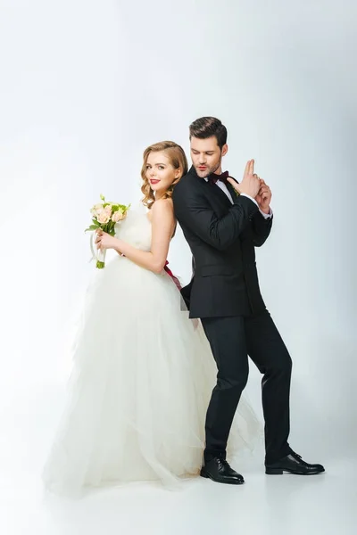 Bride and groom standing back to back together — Stock Photo