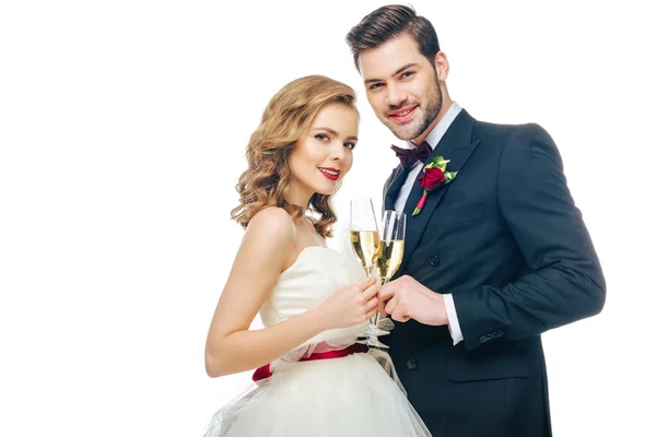 Retrato de belo casal de casamento com copos de champanhe isolado em branco — Fotografia de Stock