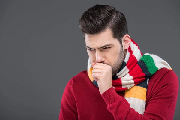 Sick man coughing in warm scarf, isolated on grey — Stock Photo