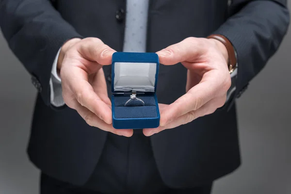 Cropped view of man proposing with ring, isolated on grey — Stock Photo