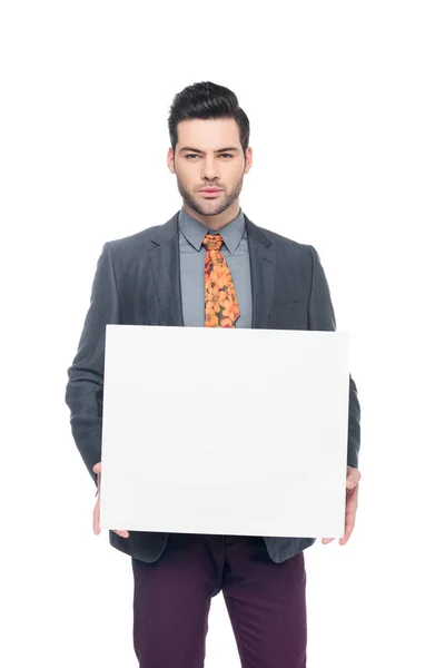 Bearded businessman in suit holding blank board, isolated on white — Stock Photo