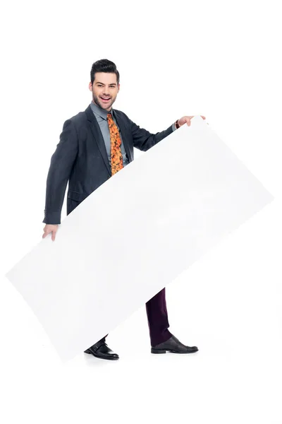 Bearded businessman in suit holding blank placard, isolated on white — Stock Photo