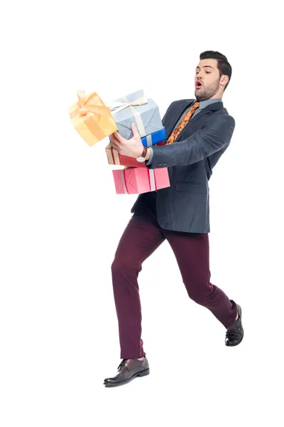 Homem bonito com caixas de presente caindo, isolado em branco — Fotografia de Stock