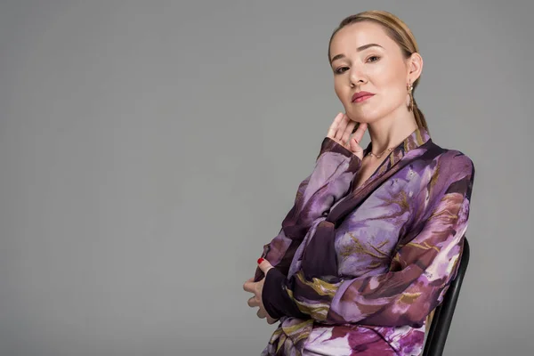 Portrait of beautiful elegant kazakh woman looking at camera isolated on grey — Stock Photo