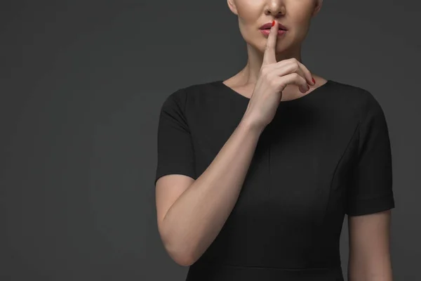 Cropped shot of kazakh woman gesturing for silence isolated on grey — Stock Photo
