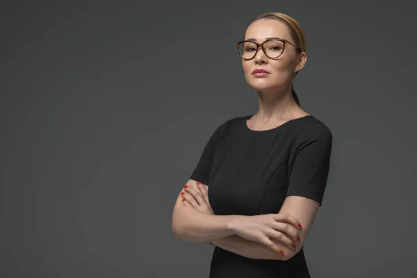 Portrait of beautiful kazakh woman in eyeglasses looking at camera isolated on grey — Stock Photo