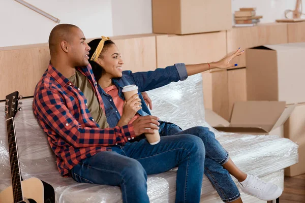 Happy african american couple planning the future in new apartment — Stock Photo