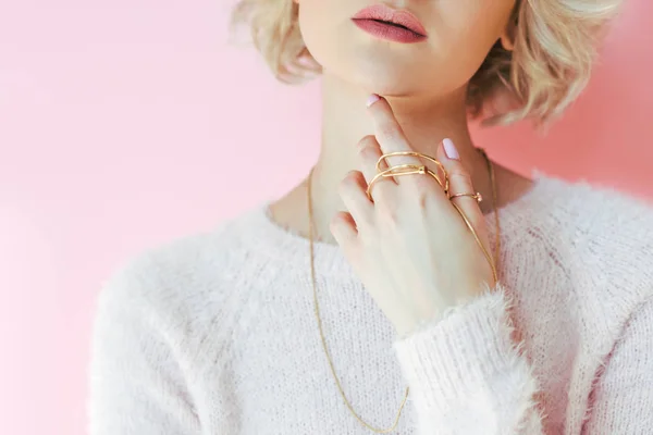 Cropped shot of sensual young woman holding jewelry in hand isolated on pink — Stock Photo