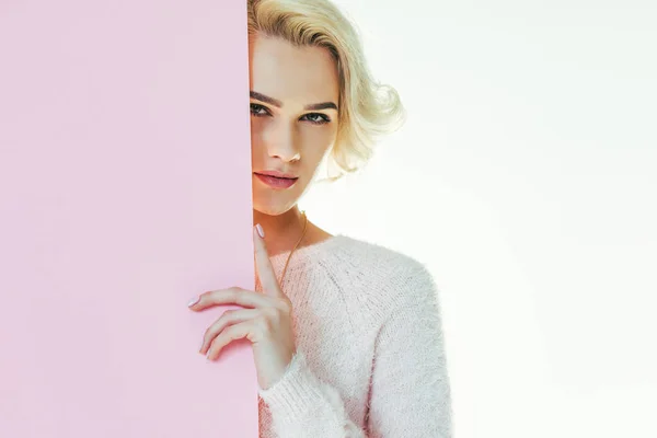 Beautiful blonde girl with pink banner looking at camera isolated on white — Stock Photo