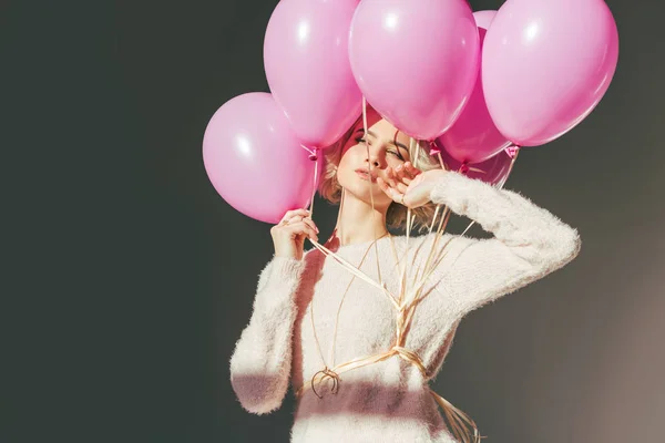 Jeune femme sensuelle posant avec des ballons roses isolés sur gris — Photo de stock