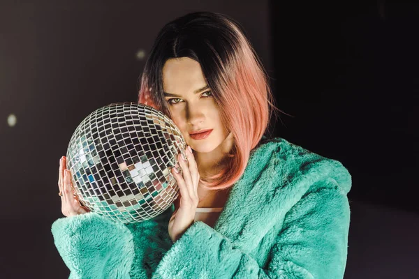 Beautiful girl with pink hair holding disco ball — Stock Photo