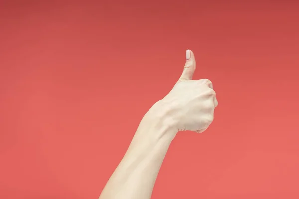 Cropped view of female hand with thumb up, isolated on red — Stock Photo