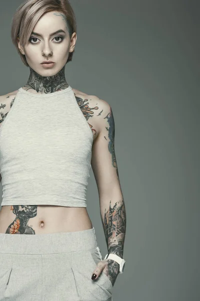 Beautiful tattooed girl, isolated on grey — Stock Photo