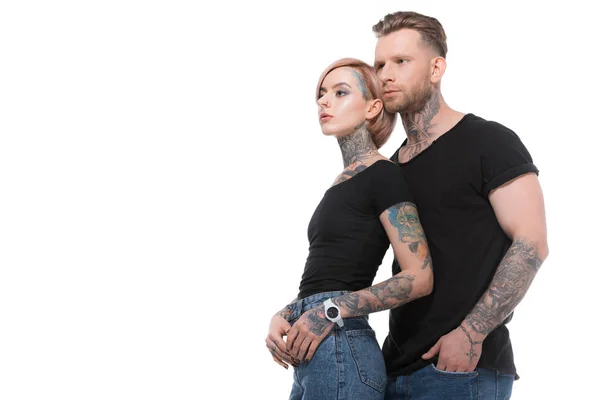 Fashionable tattooed couple posing together, isolated on white — Stock Photo
