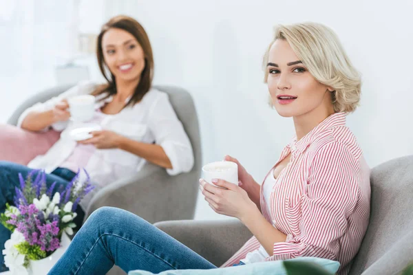 Foco seletivo de mulheres com xícaras de café passar tempo juntos — Fotografia de Stock