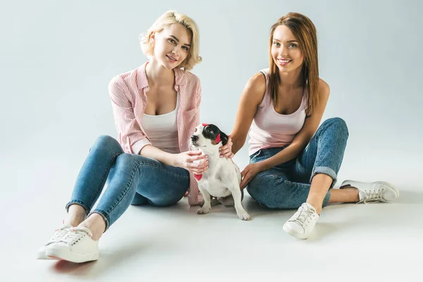 Beautiful girls with jack russell terrier dog in red hearts, on white — Stock Photo