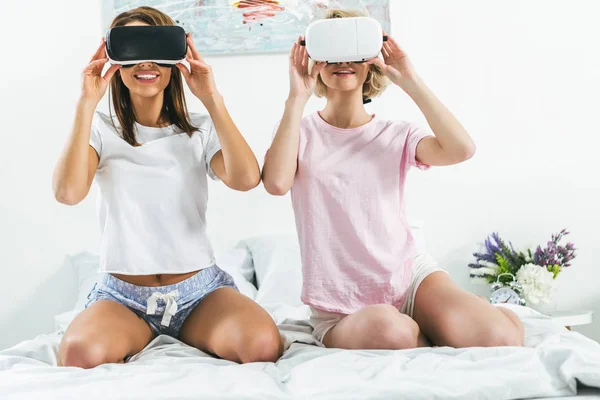 Chicas hermosas usando auriculares de realidad virtual en casa — Stock Photo