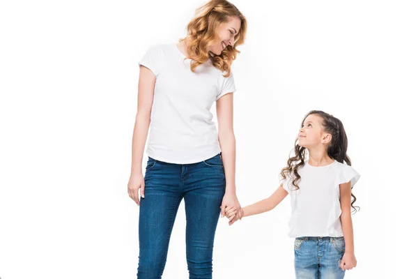 Smiling mother and little daughter holding hands isolated on white — Stock Photo