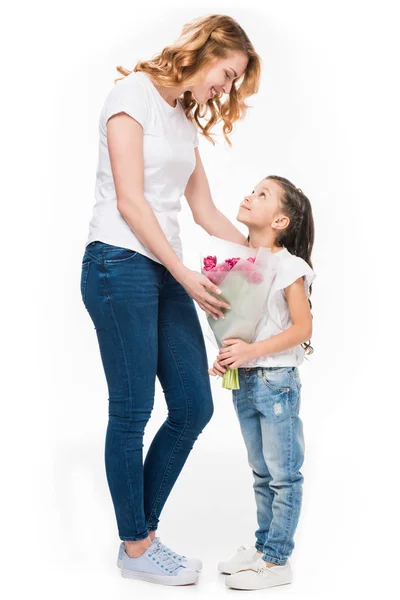 Happy mother and little daughter with bouquet of flowers isolated on white, mothers day concept — Stock Photo