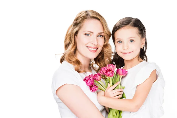 Portrait of happy mother and little daughter with bouquet of flowers isolated on white, mothers day holiday concept — Stock Photo