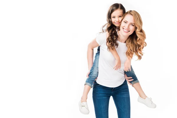 Happy mother and daughter piggybacking together isolated on white — Stock Photo