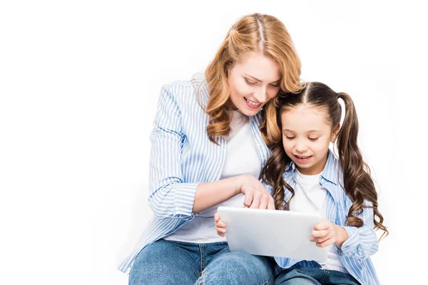 Portrait of mother and daughter using tablet together isolated on white — Stock Photo