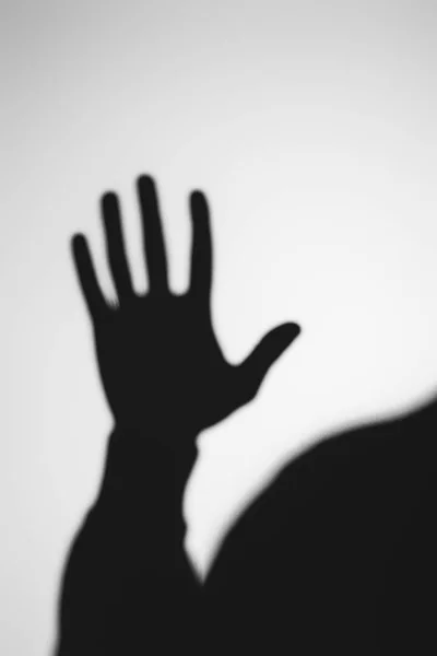 Strange blurry shadow of human hand on grey — Stock Photo