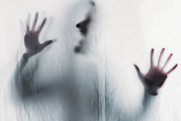 Scary blurry silhouette of unrecognizable person screaming behind veil — Stock Photo