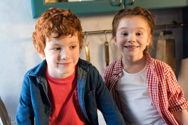 Adorable happy little kids smiling together in kitchen — Stock Photo