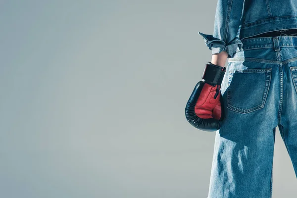 Cropped view of girl in jeans and boxing gloves, isolated on grey — Stock Photo