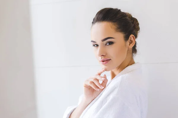 Side view of beautiful young woman in bathrobe at home — Stock Photo