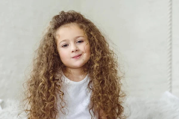 Portrait of adorable curly child looking at camera — Stock Photo